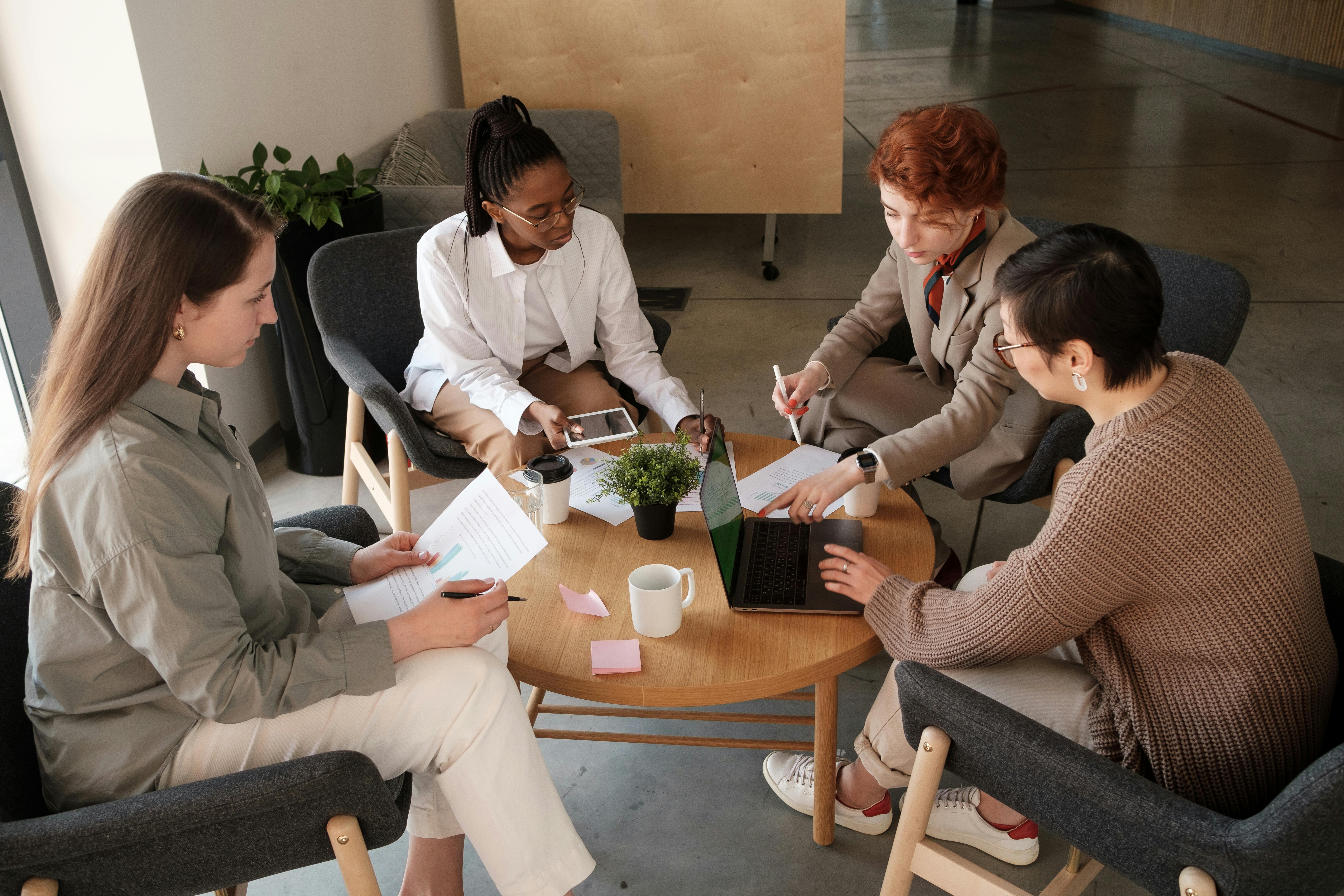 people sitting around a coffee table working