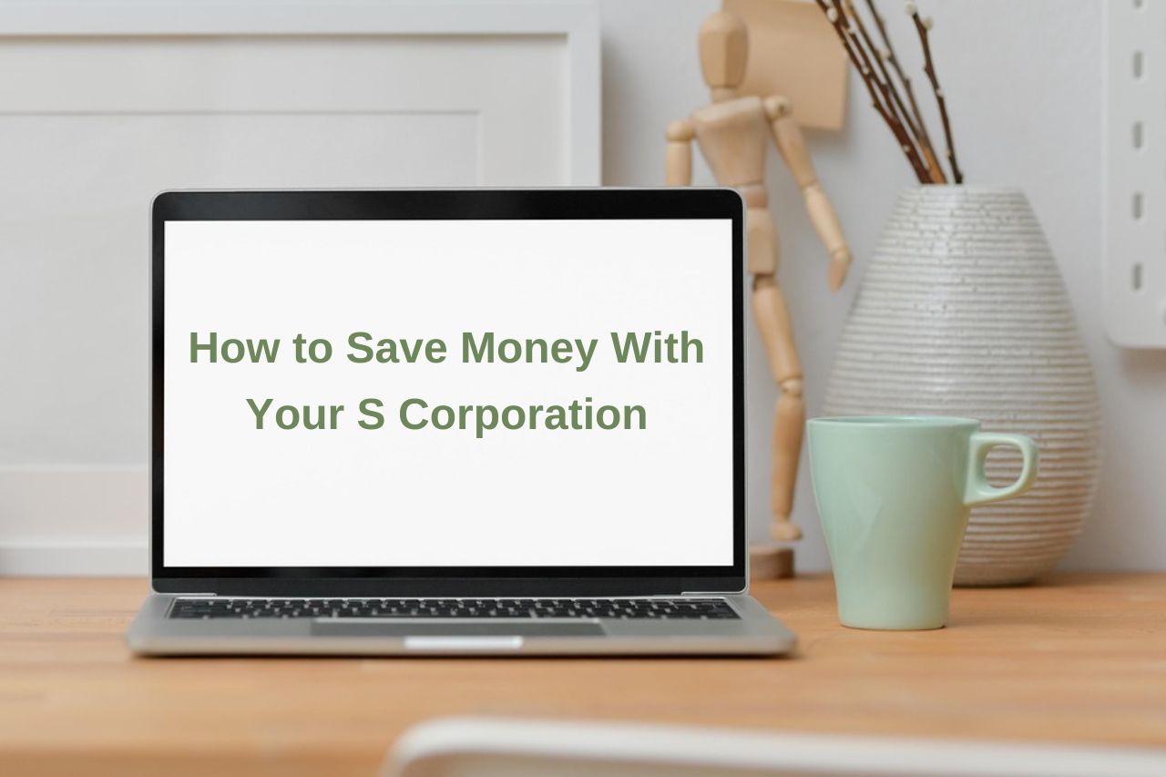 laptop on desk with much and vase