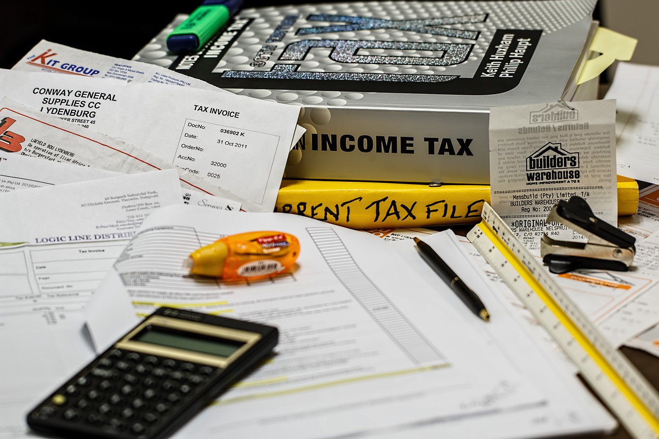 a messy desk with paperwork and income tax books