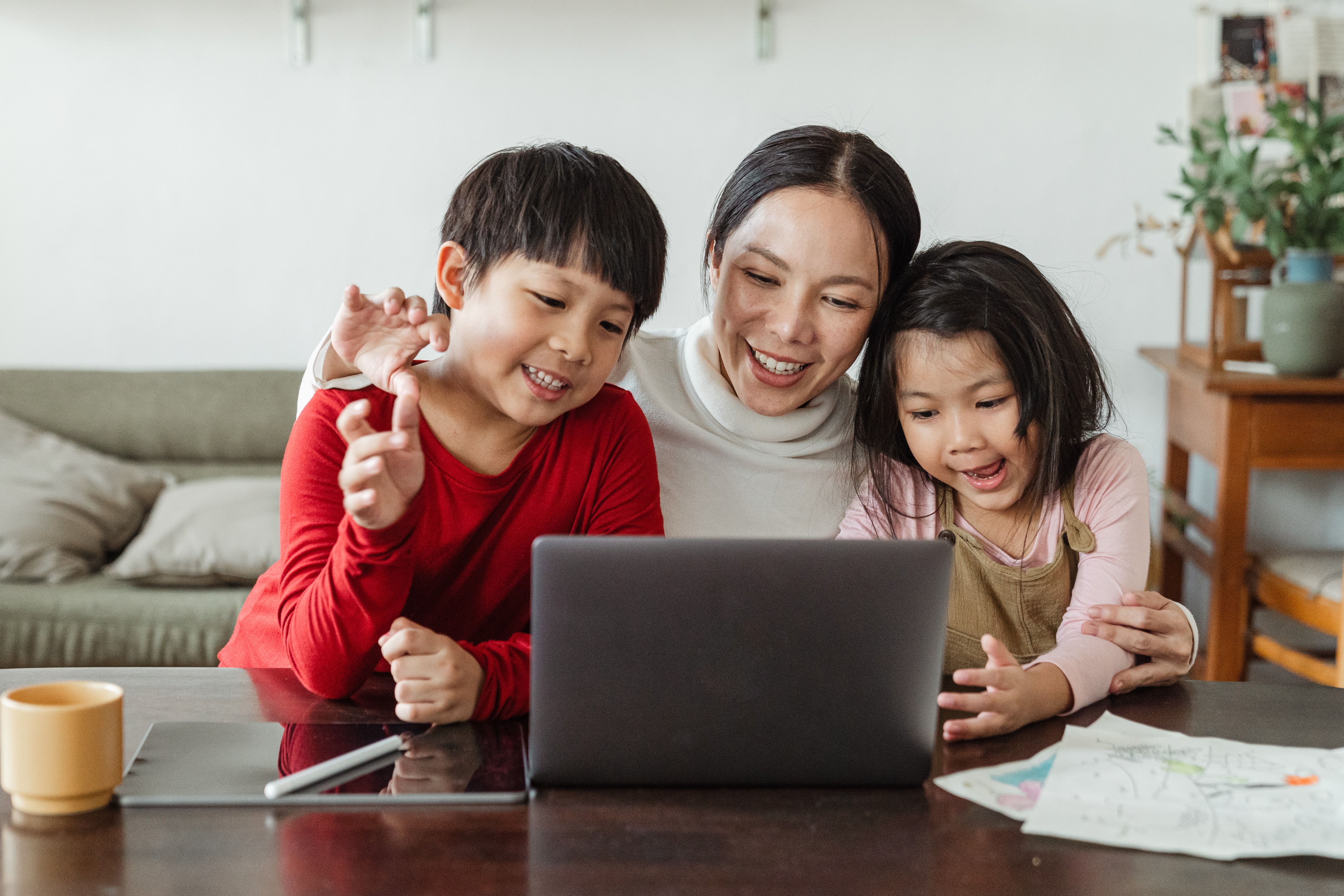 mother and two children at laptop