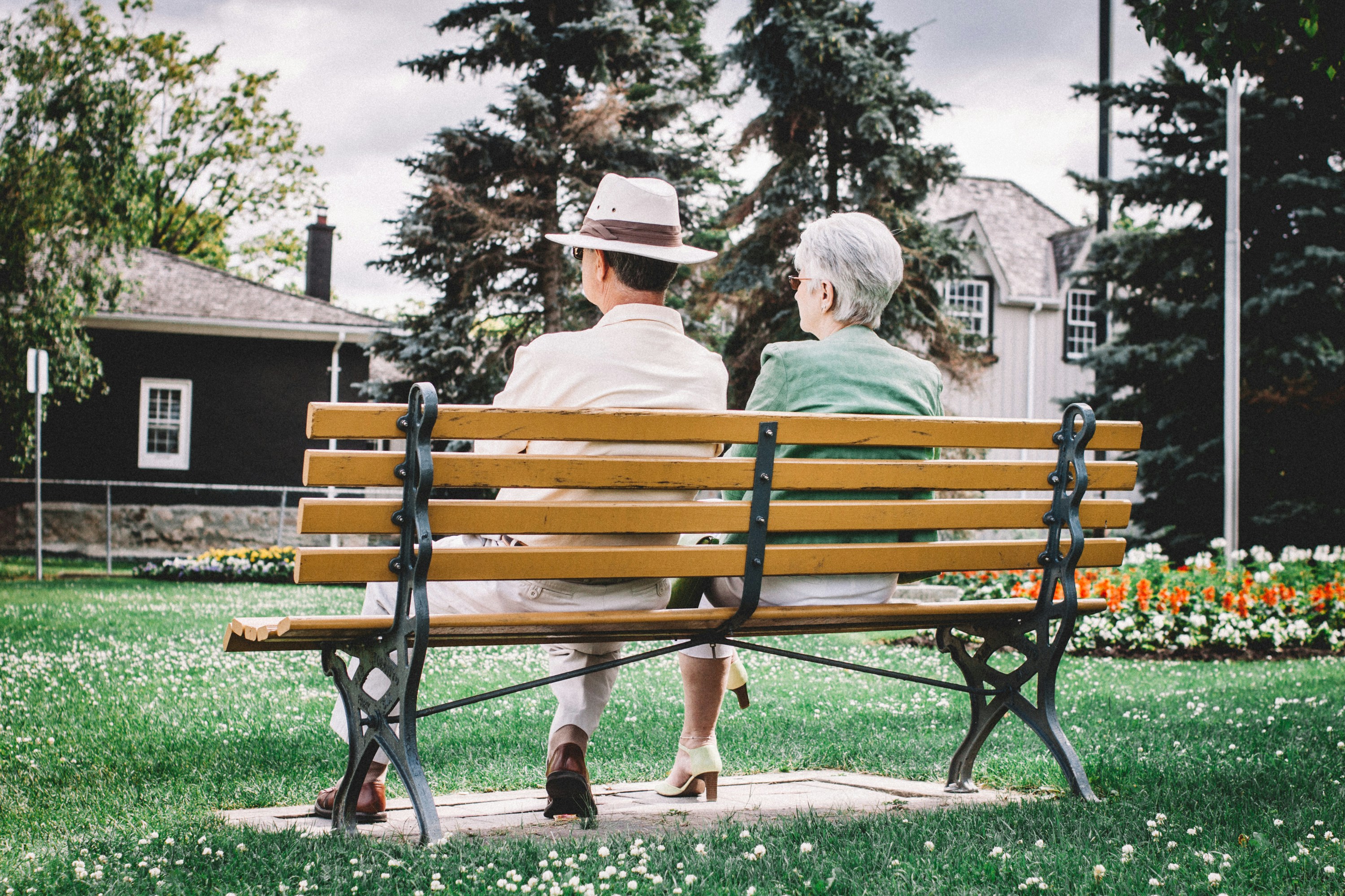 older couple sitting on bench outside